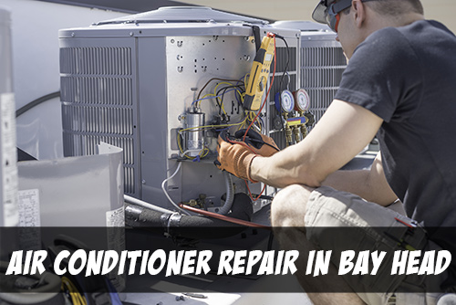 Air conditioner repair in Bay Head in white text on bottom of picture of man crouching in front of a condensor with a variety of tools